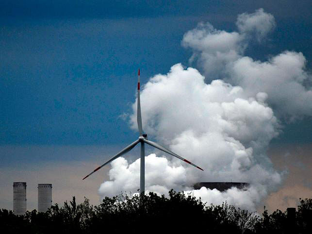 A wind turbine stands in front of a coal-fired power plant of German energy giant RWE near Niederaussem, western Germany. Photo taken on 5 September 2019. AFP file photo