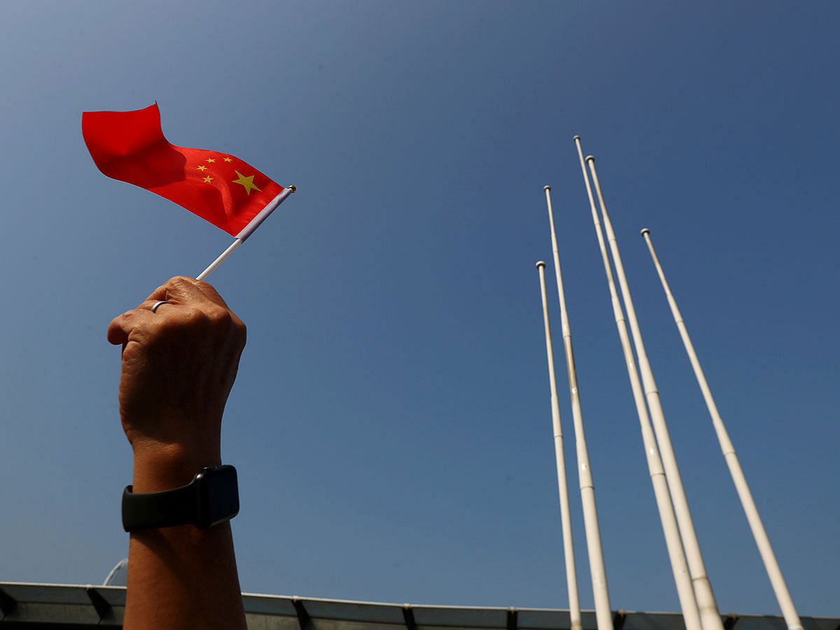 A pro-China supporter holds up a China national flag at Harbour City, during China`s National Day in Hong Kong, China on 1 October 2019. Photo: Reuters
