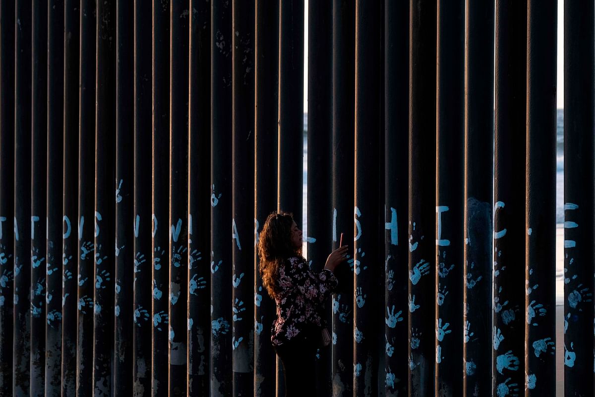 A visitor takes a picture of the US-Mexico border fence in Playas de Tijuana, Baja California state, Mexico on 29 September 2019. Photo: AFP