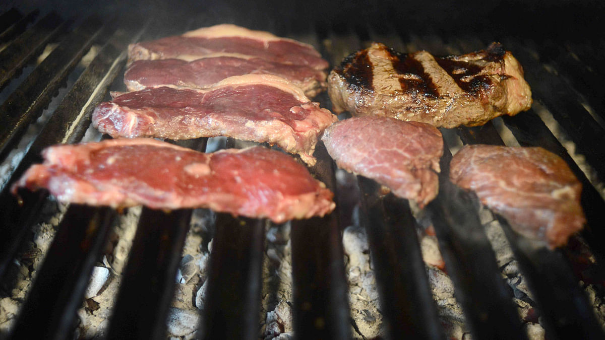 In this file photo taken on 27 October 2015 beef cuts are grilled at a traditional restaurant in Buenos Aires. AFP File Photo