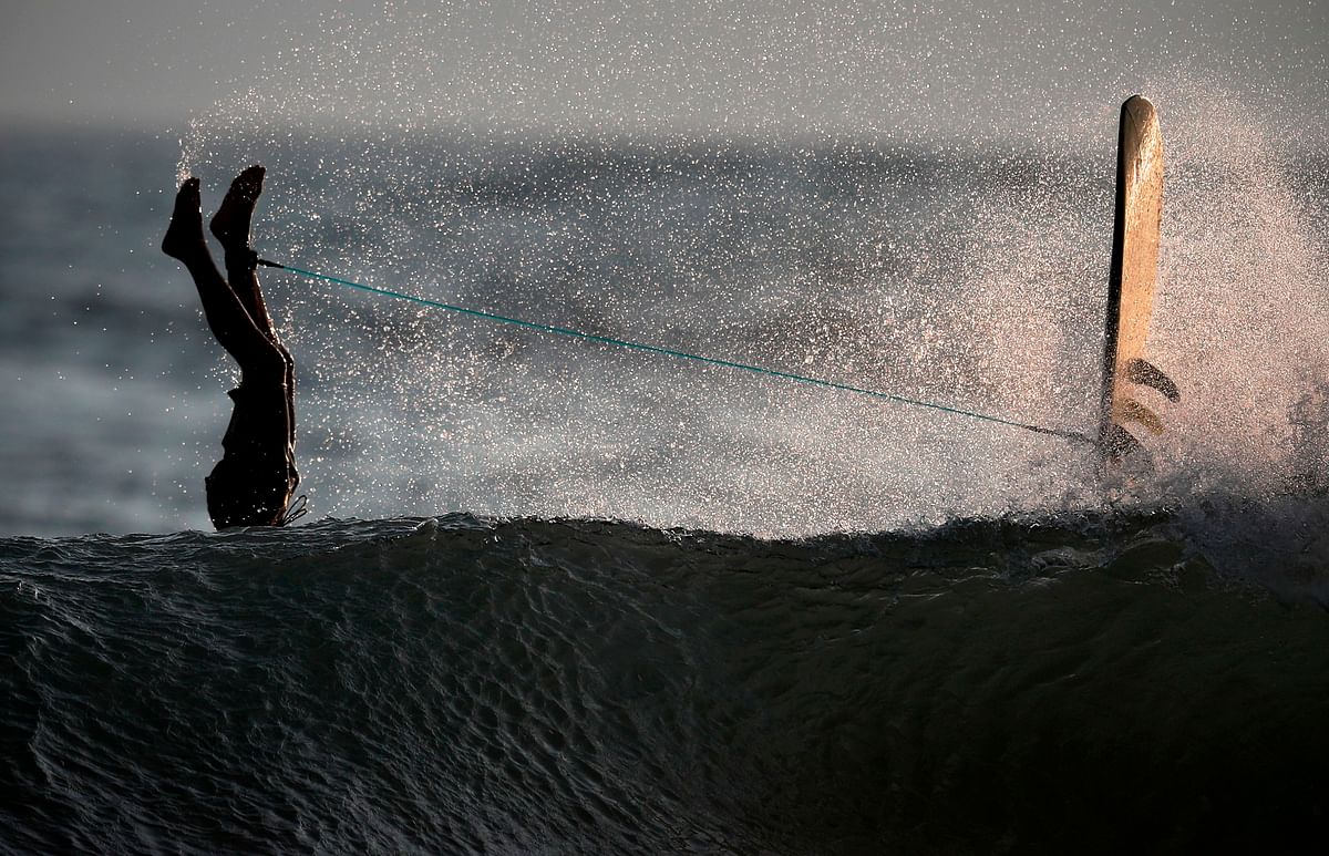 A surfer flips into the water as he crashes over the top of a wave in the ocean at Omaezaki on 1 October 2019. Japan is hosting the 2019 Rugby World Cup from 20 September to 2 November 2019. Photo: AFP