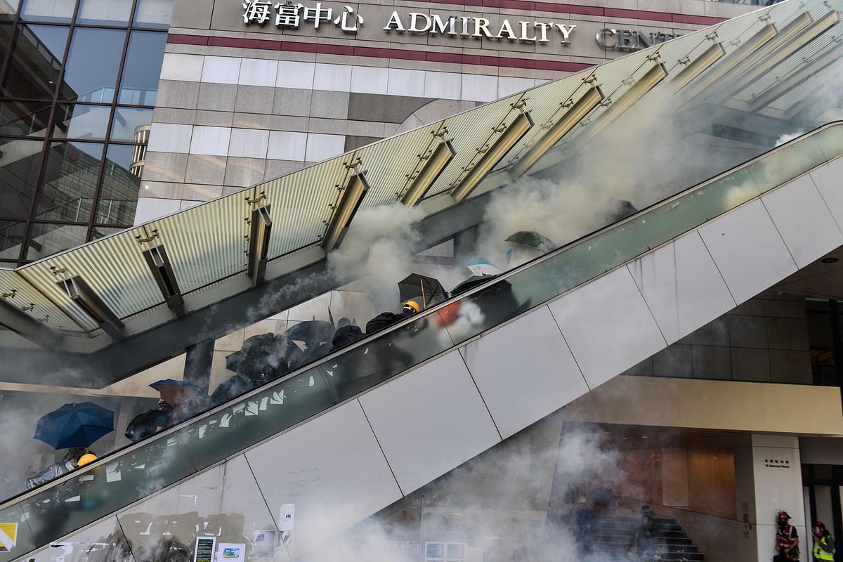 Protesters react after police fired tear gas near the central government offices in the Admiralty area in Hong Kong on 1 October 2019, as the city observes the National Day holiday to mark the 70th anniversary of communist China`s founding. Photo: AFP
