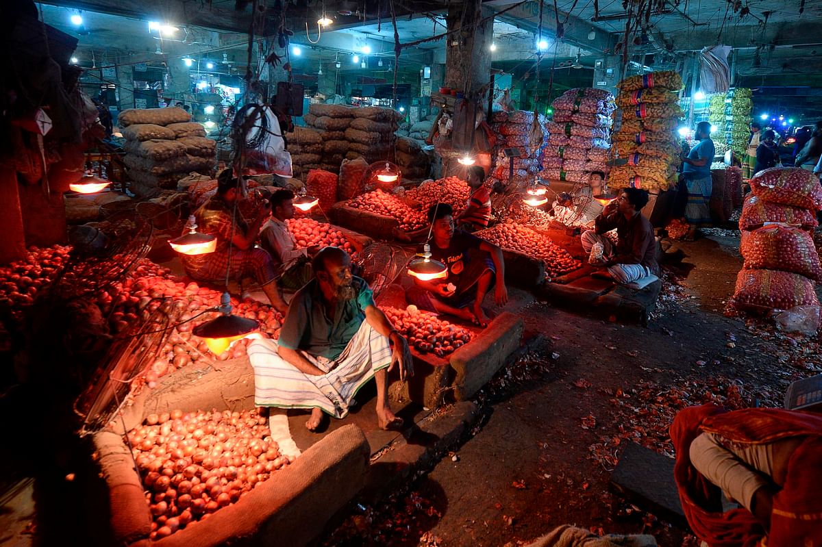 Salesmen wait for customers at Kawran Bazaar wholesale market in Dhaka on 2 October 2019. Onion prices have rocketed in Bangladesh after India banned its export over local shortages, forcing the government to import the vegetable from other countries and sell it at subsidised prices. Photo: AFP