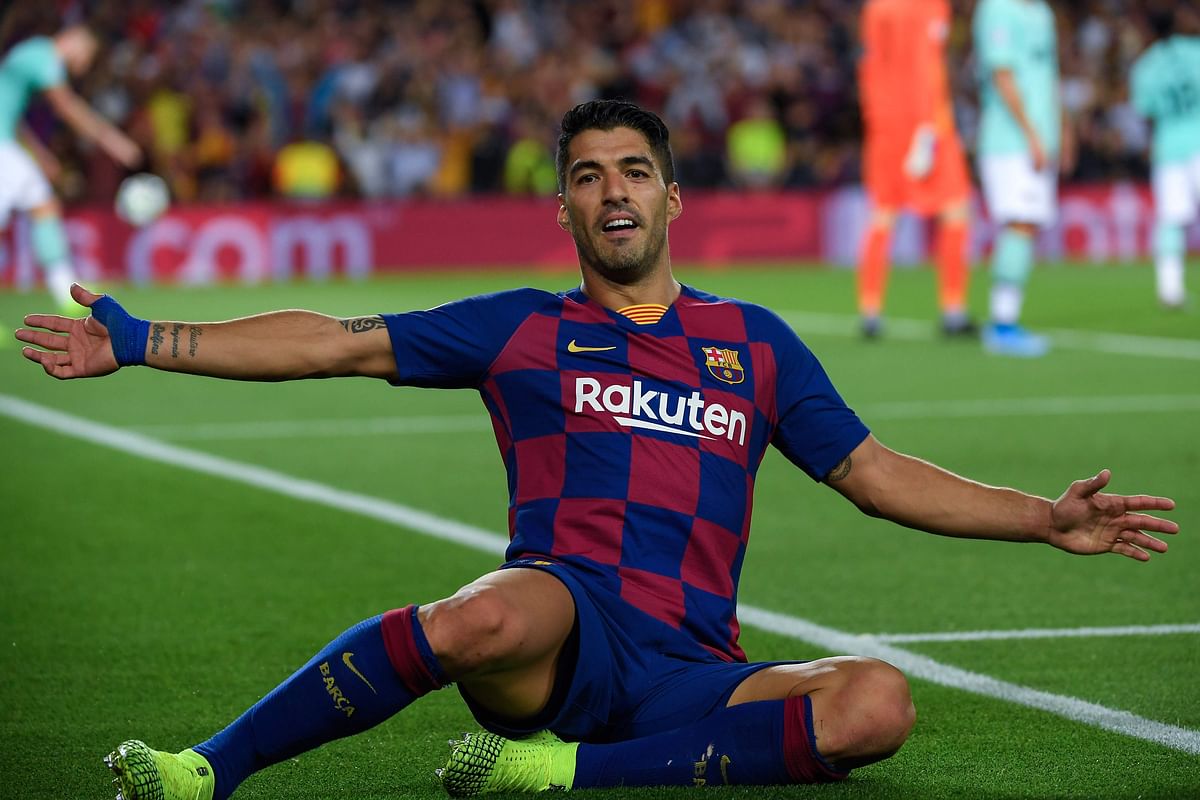 Barcelona`s Uruguayan forward Luis Suarez celebrates after scoring a goal during the UEFA Champions League Group F football match between Barcelona and Inter Milan at the Camp Nou stadium in Barcelona, on Wednesday. Photo: AFP
