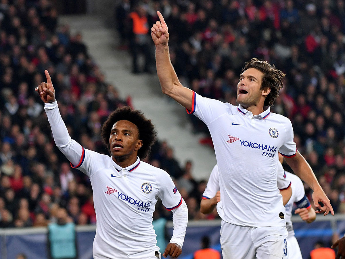 Chelsea`s Brazilian midfielder Willian (L) celebrates scoring his team`s second goal during the UEFA Champions League Group H football match between Lille anf Chelsea, on Wednesday. Photo: AFP