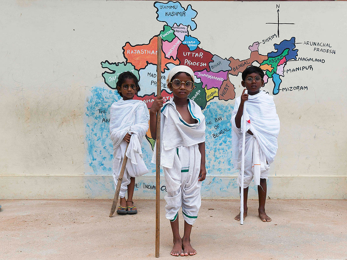 Students dressed like Indian independence icon Mahatma Gandhi, gather during an event at a school in Chennai on 2 October 2019, to mark Gandhi`s 150th birth anniversary. Photo: AFP