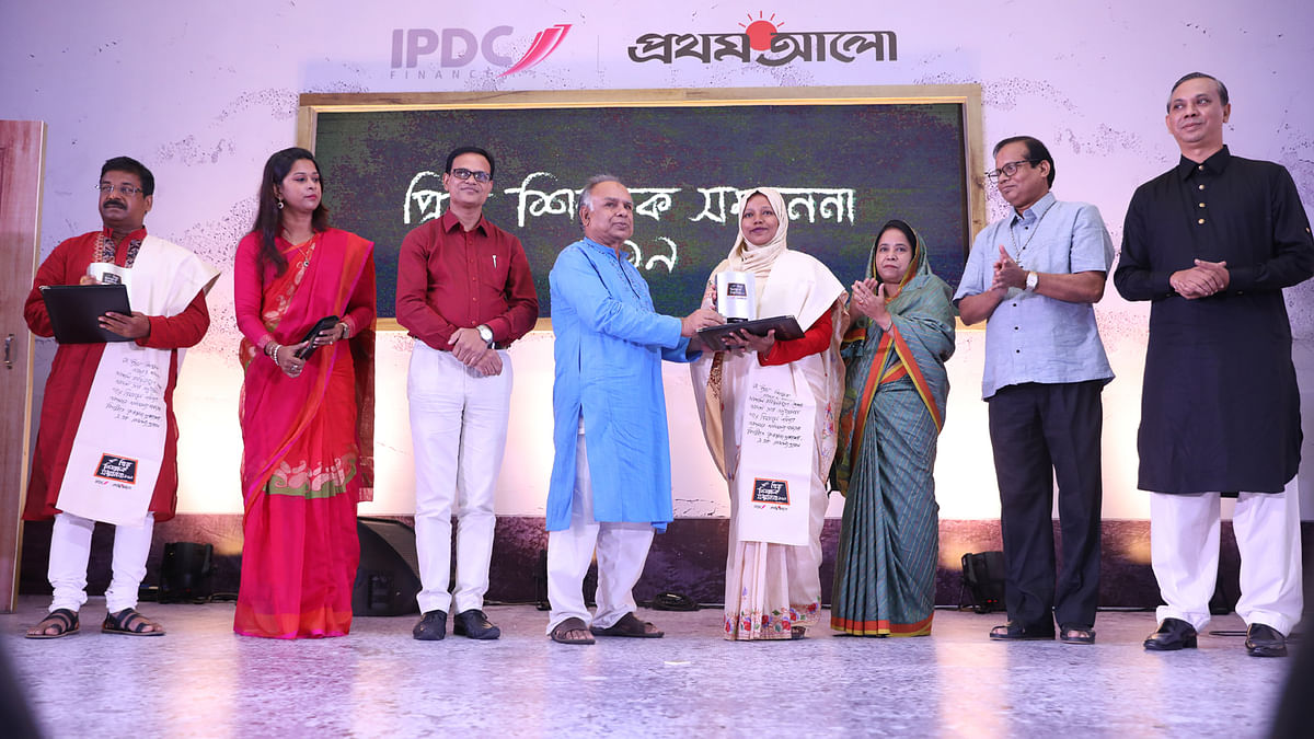 Head teacher of Biddyamoyi Government Girls School of Mymensingh Nashima Akhter receiving award from jury board member and former chairman of Jashore Eduction Board Amirul Alam. Photo: Prothom Alo.