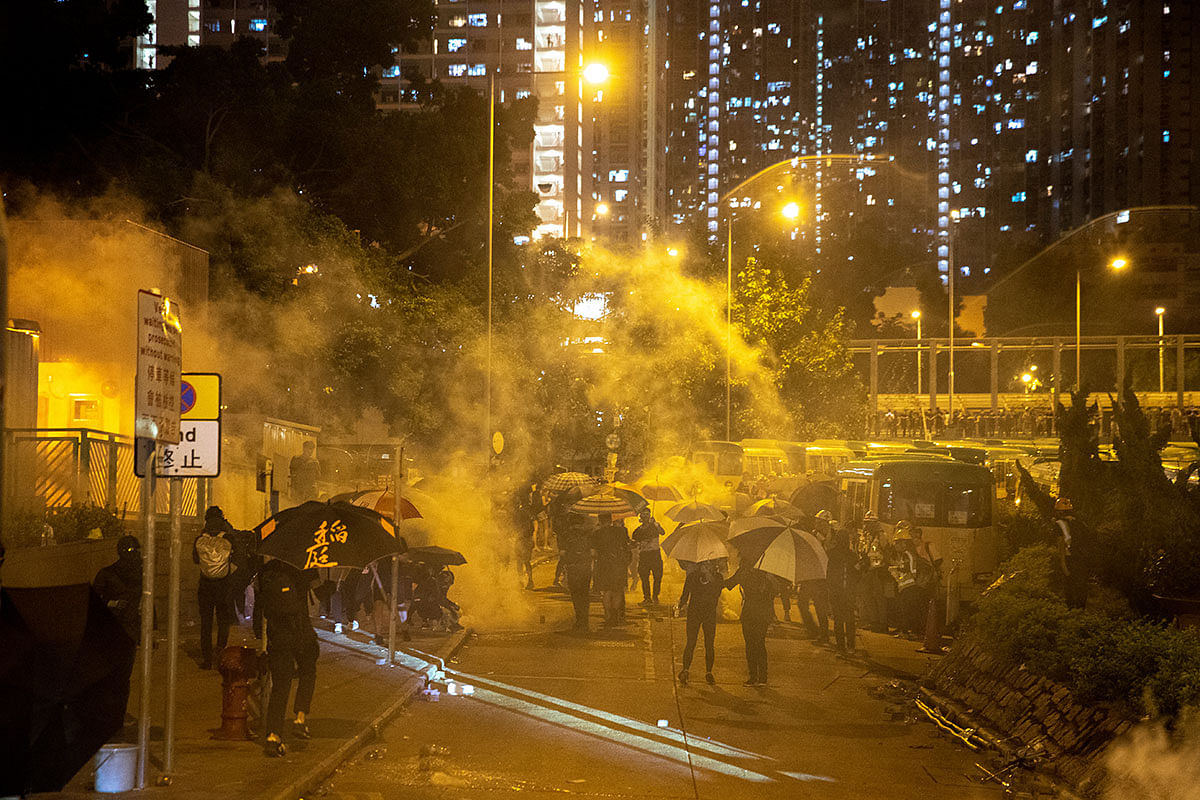 Anti-government protesters run away from a tear gas canister, after leader Carrie Lam announced emergency laws that would include banning face masks at protests, in Wong Tai Sin district, in Hong Kong, China on 4 October 2019. Photo: Reuters