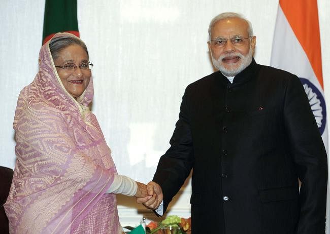 In this photograph released by the Press Information Bureau (PIB) on 28 September 2014 and taken 27 September 2014 Prime Minister Sheikh Hasina (L) shakes hands with Indian prime minister Narendra Modi during a bilateral meeting in New York. AFP File Photo