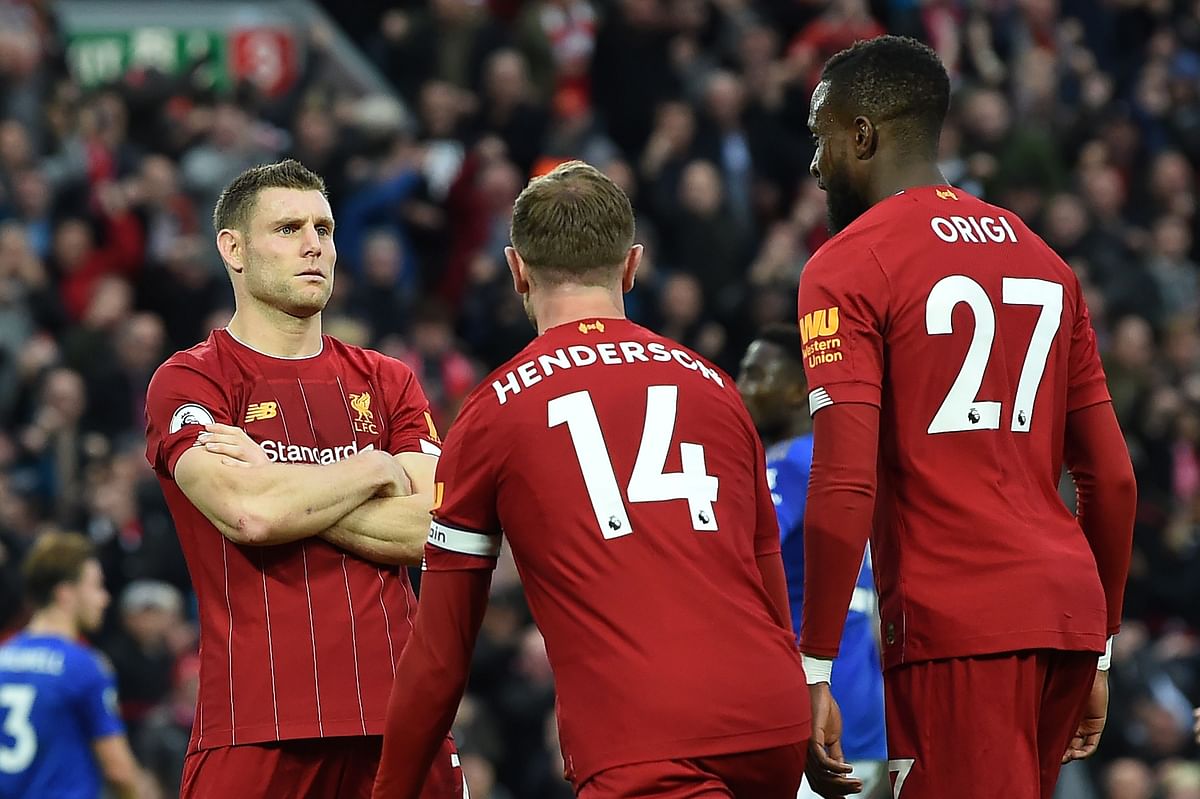 Liverpool`s English midfielder James Milner (L) celebrates with Liverpool`s English midfielder Jordan Henderson and Liverpool`s Belgium striker Divock Origi (R) after taking a penalty and scoring his team`s second goal during the English Premier League football match between Liverpool and Leicester City at Anfield in Liverpool, north west England on Saturday. Photo: AFP