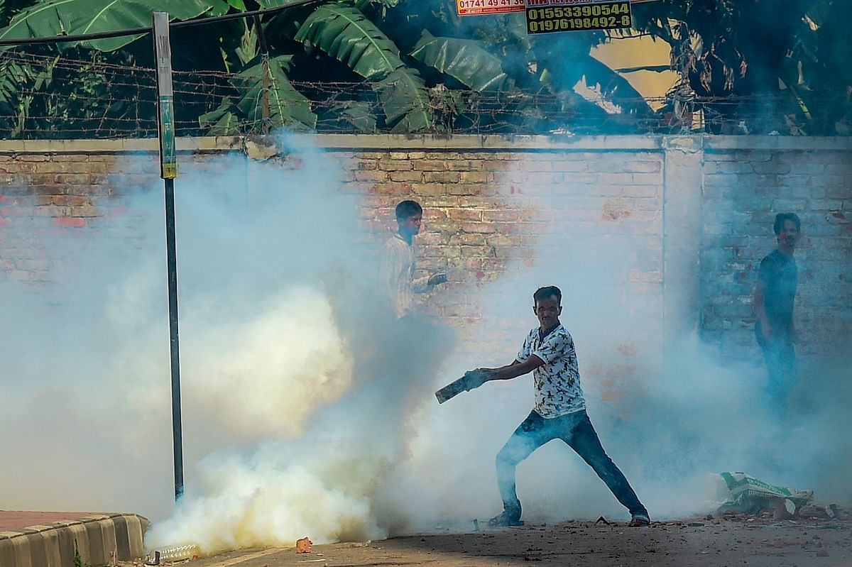 Stranded Bihari residents are seen among tear gas during a clash with security forces at Geneva Camp in Dhaka on 5 October 2019. Photo: AFP