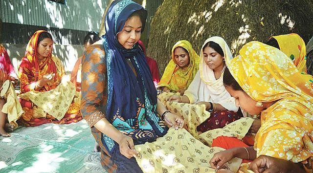 Sumana instructs women about embroidery works at village Patulipara in Bhangura, Pabna. A recent photo by Hassan Mahmud  Sewing success
