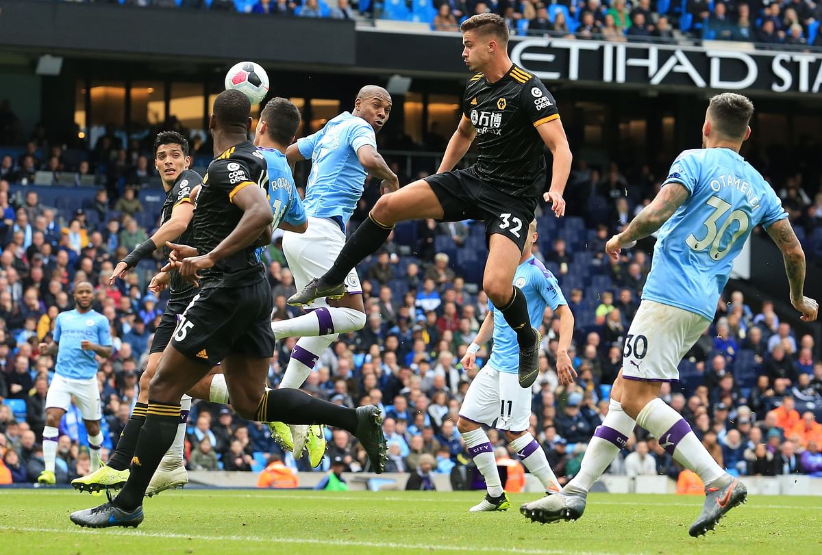 Wolverhampton Wanderers` Belgian midfielder Leander Dendoncker (C) shoots but fails to score during the English Premier League football match between Manchester City and Wolverhampton Wanderers at the Etihad Stadium in Manchester, north west England, on 6 October 2019. Photo: AFP