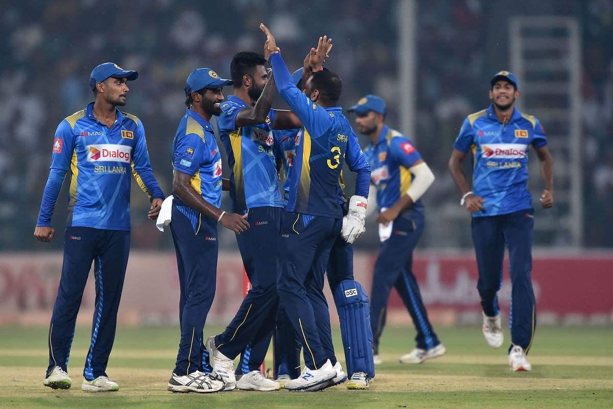 Sri Lanka`s cricketers celebrates the dismissal of Pakistan`s cricketer Kamran Akmal (unseen) during the first Twenty20 International cricket match between Pakistan and Sri Lanka at the Gaddafi stadium in Lahore on Saturday. Photo: AFP