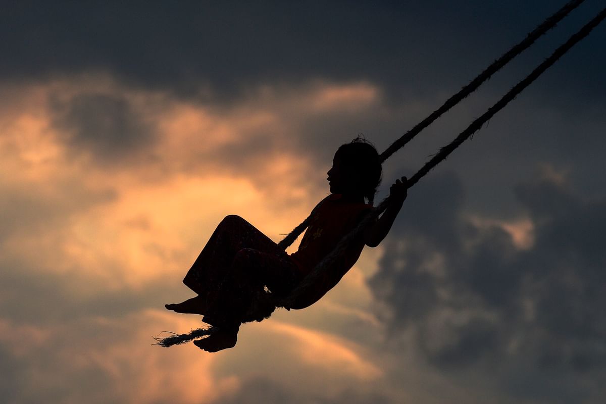 A girl plays on a swing, popularly known as the `Dashain Ping`, during the Hindu festival of `Dashain` in Changu Naryan on the outskirts of Kathmandu on 6 October 2019. Photo: AFP