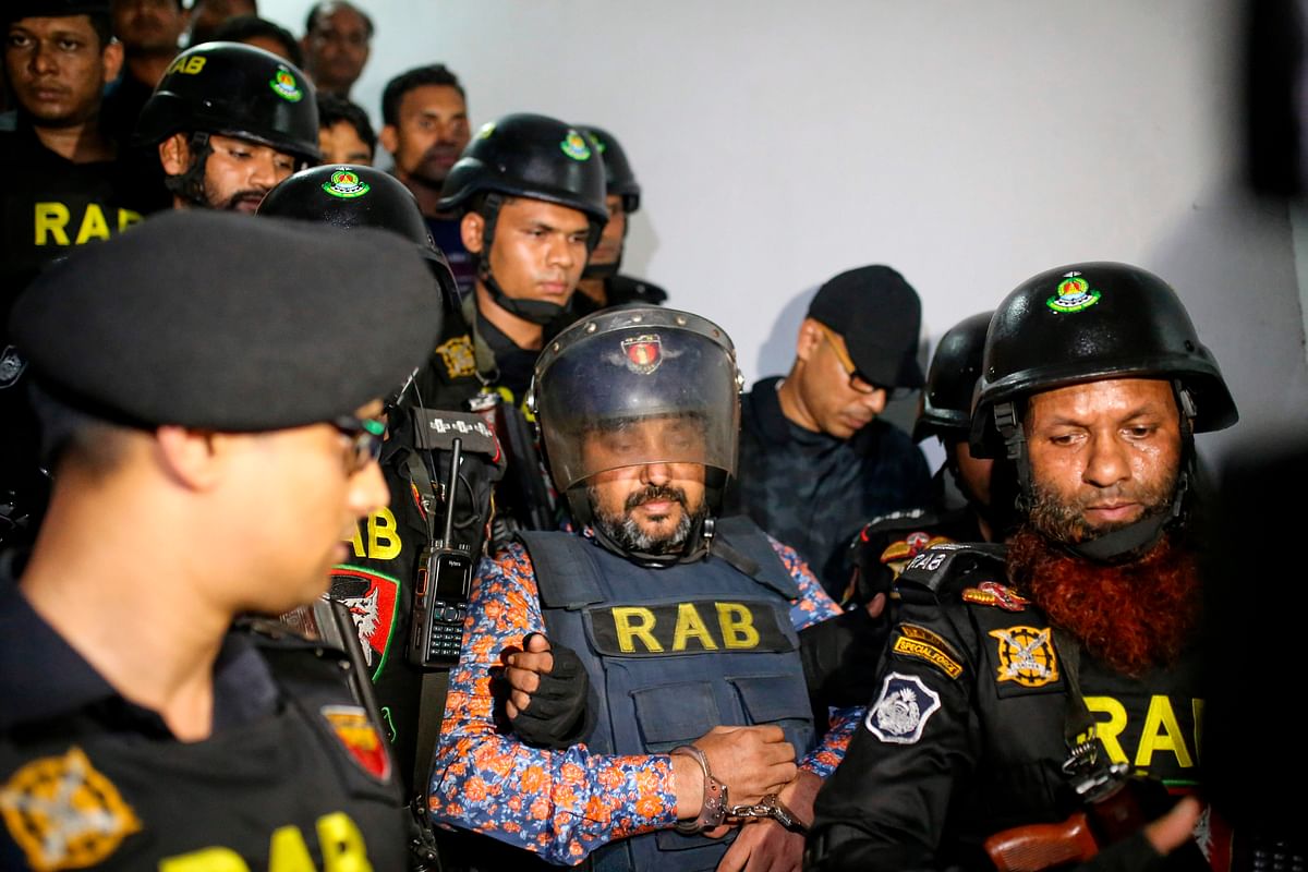 Rapid Action Battalion (RAB) escort ruling party leader Ismail Hossain Samrat following his arrest in Dhaka on 6 October 2019. Photo: AFP