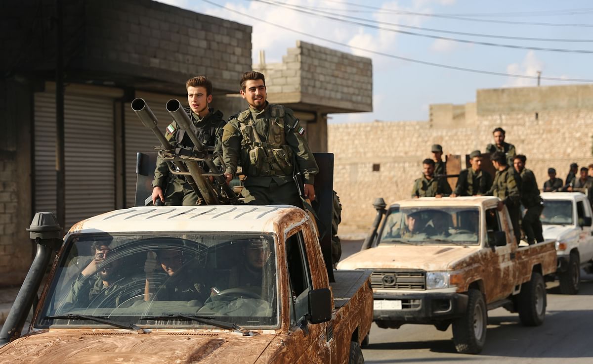 Turkish-backed Syrian rebel fighters gather near the Syrian-Turkish border north of Aleppo on 7 October 2019. US forces in northern Syria started pulling back from areas along the Turkish border ahead of a feared military invasion by Ankara that Kurdish forces say would spark a jihadist resurgence. Photo: AFP
