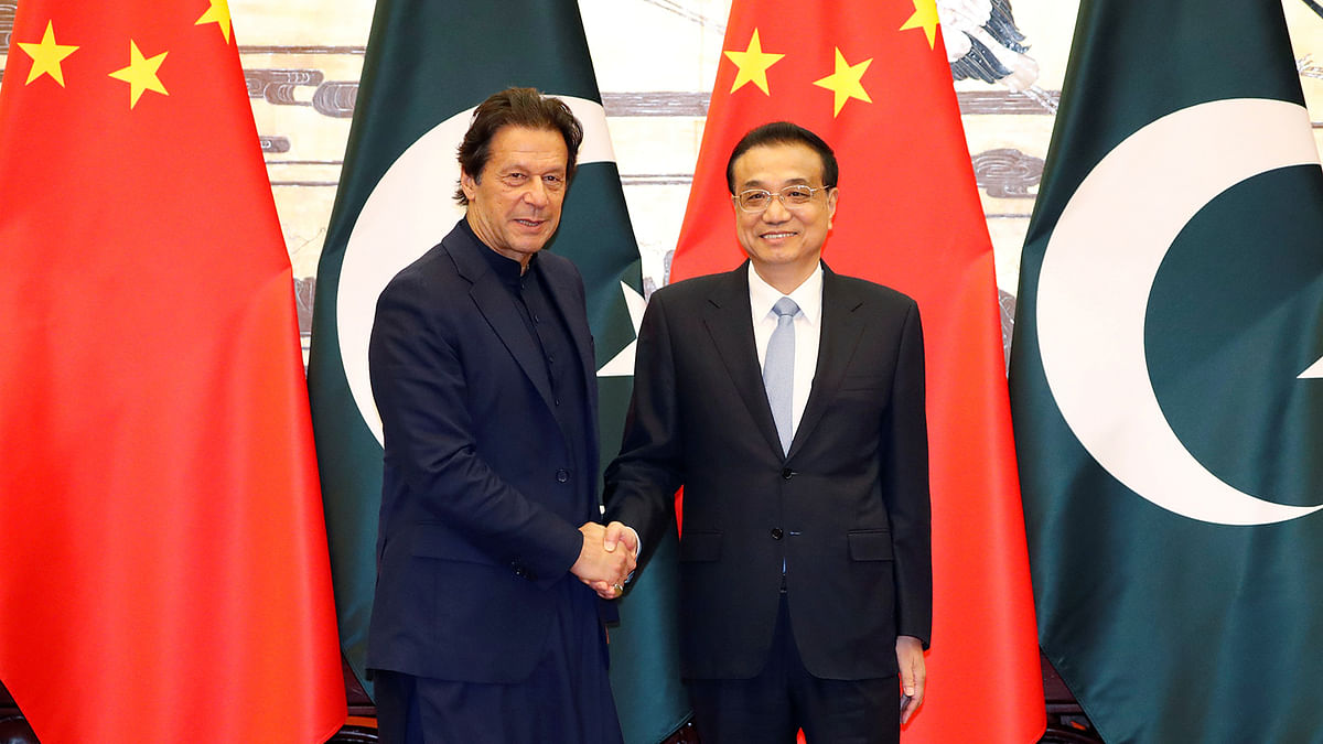 Pakistan`s prime minister Imran Khan and Chinese premier Li Keqiang shake hands during a signing ceremony at the Great Hall of the People in Beijing, China, on 8 October 2019. Photo: Reuters