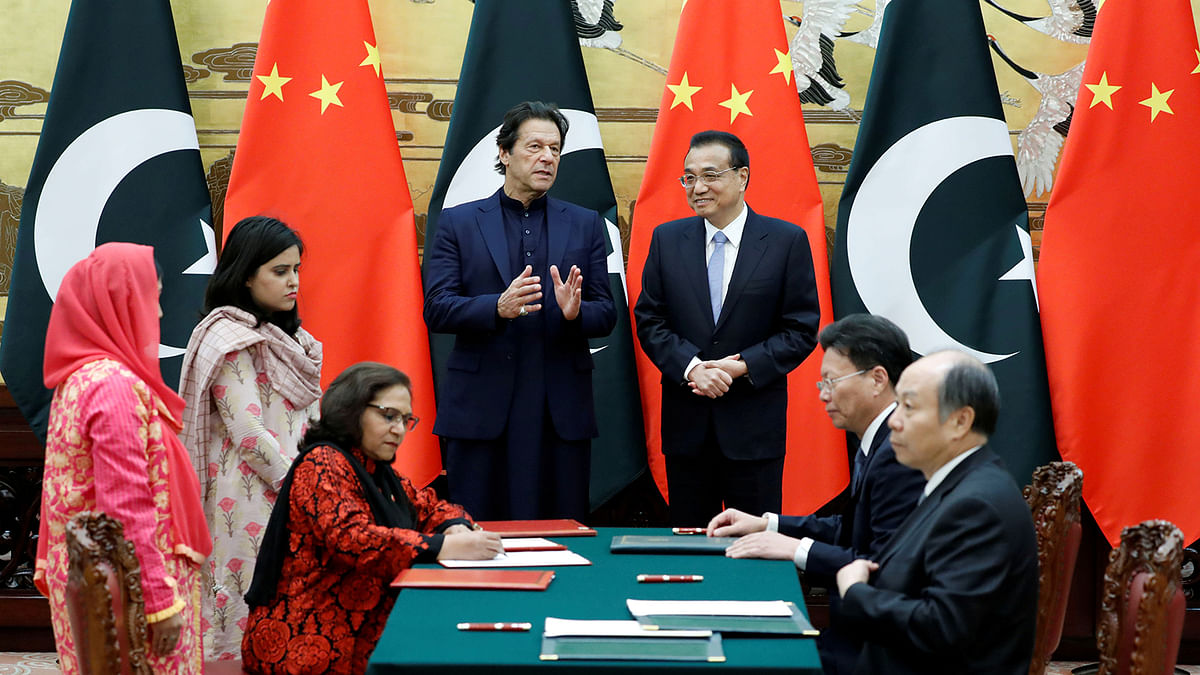 Pakistan`s prime minister Imran Khan chats with Chinese premier Li Keqiang during a signing ceremony at the Great Hall of the People in Beijing, China, on 8 October 2019. Photo: Reuters