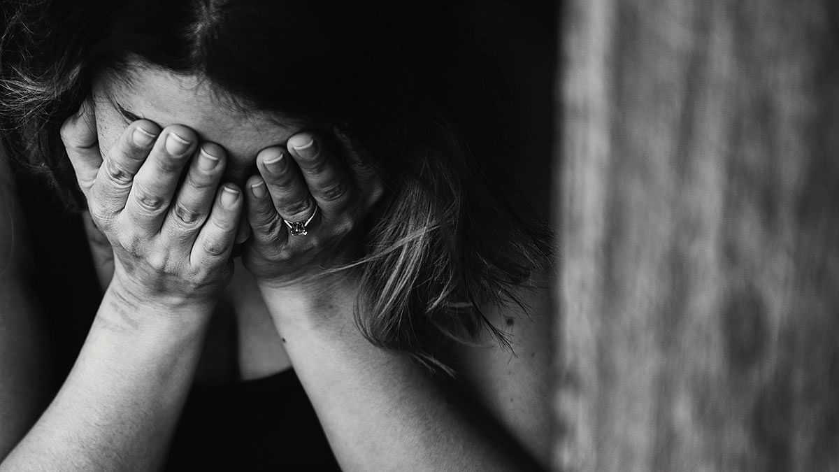 A victim of human trafficking hides her face. Photo: Kat Jayne from Pexels