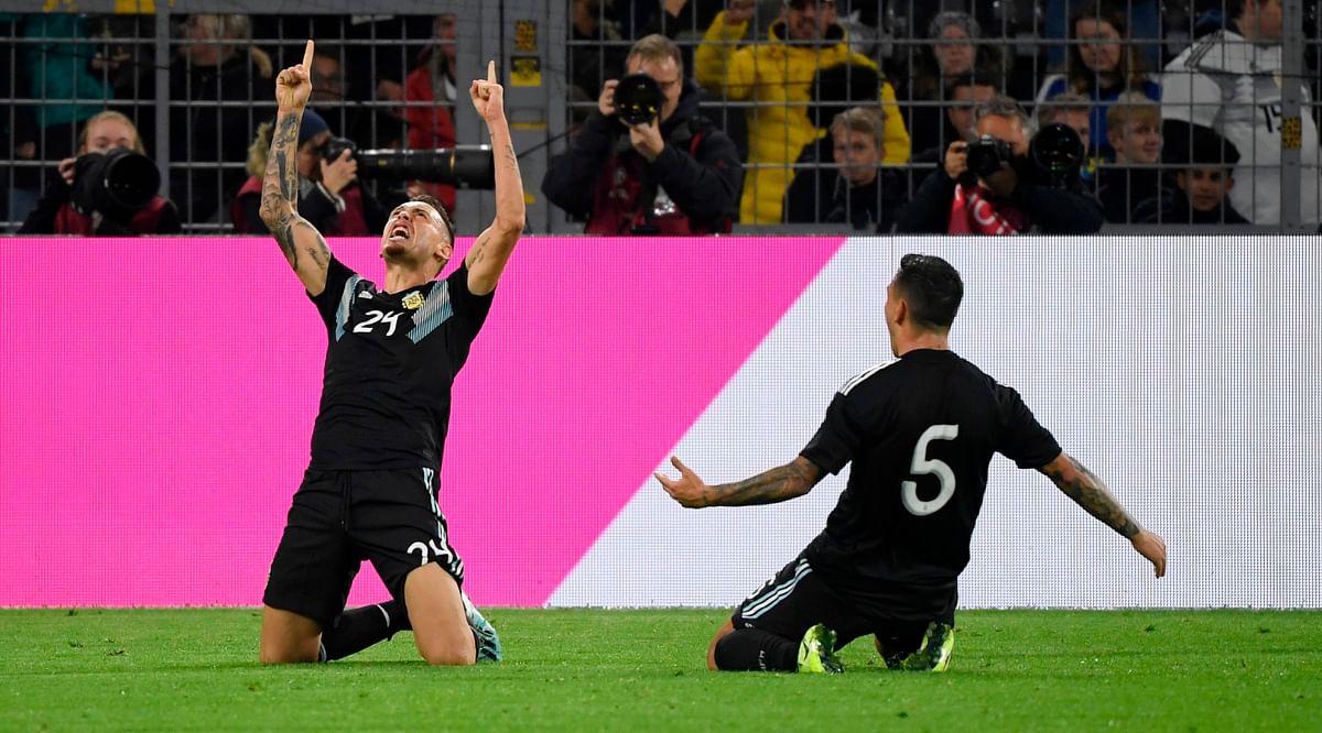 Argentina`s midfielder Lucas Ocampos (L) and Argentina`s midfielder Leandro Paredes celebrate the 2-2 goal during the friendly football match Germany v Argentina at the Signal-Iduna Park in Dortmund, western Germany on 9 October 2019. Photo: AFP