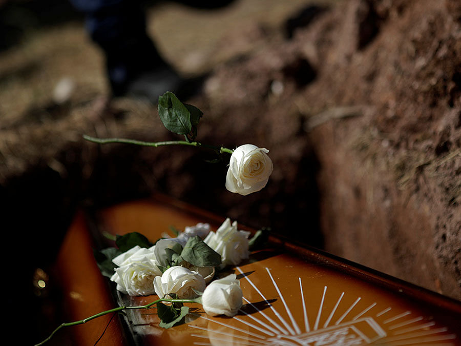 Relatives throw flowers on the coffin of DJ Joao Vitor, who was shot dead holding a drilling machine during a police operation in Santa Maria slum, in Rio de Janeiro, Brazil on 4 April. Photo: Reuters
