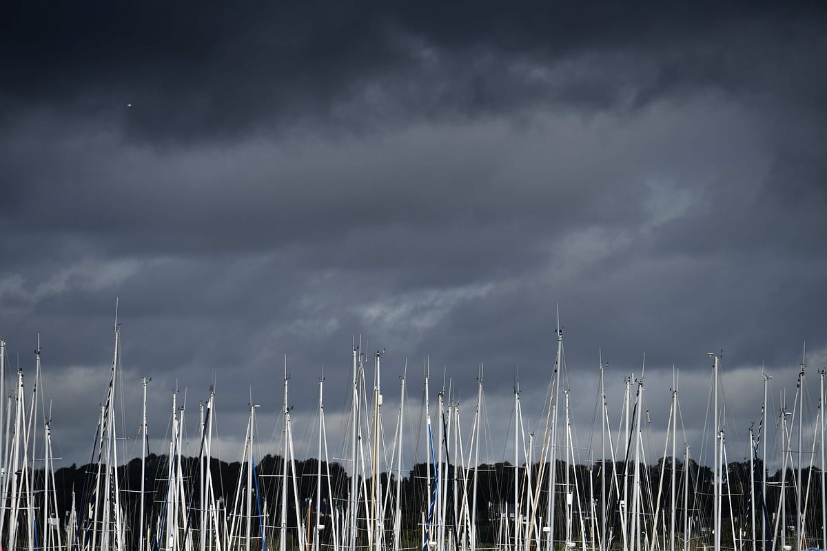 This picture taken on 10 October 2019 shows poles under a cloudy sky at the marina of Port-la-Foret, western France. Photo: AFP