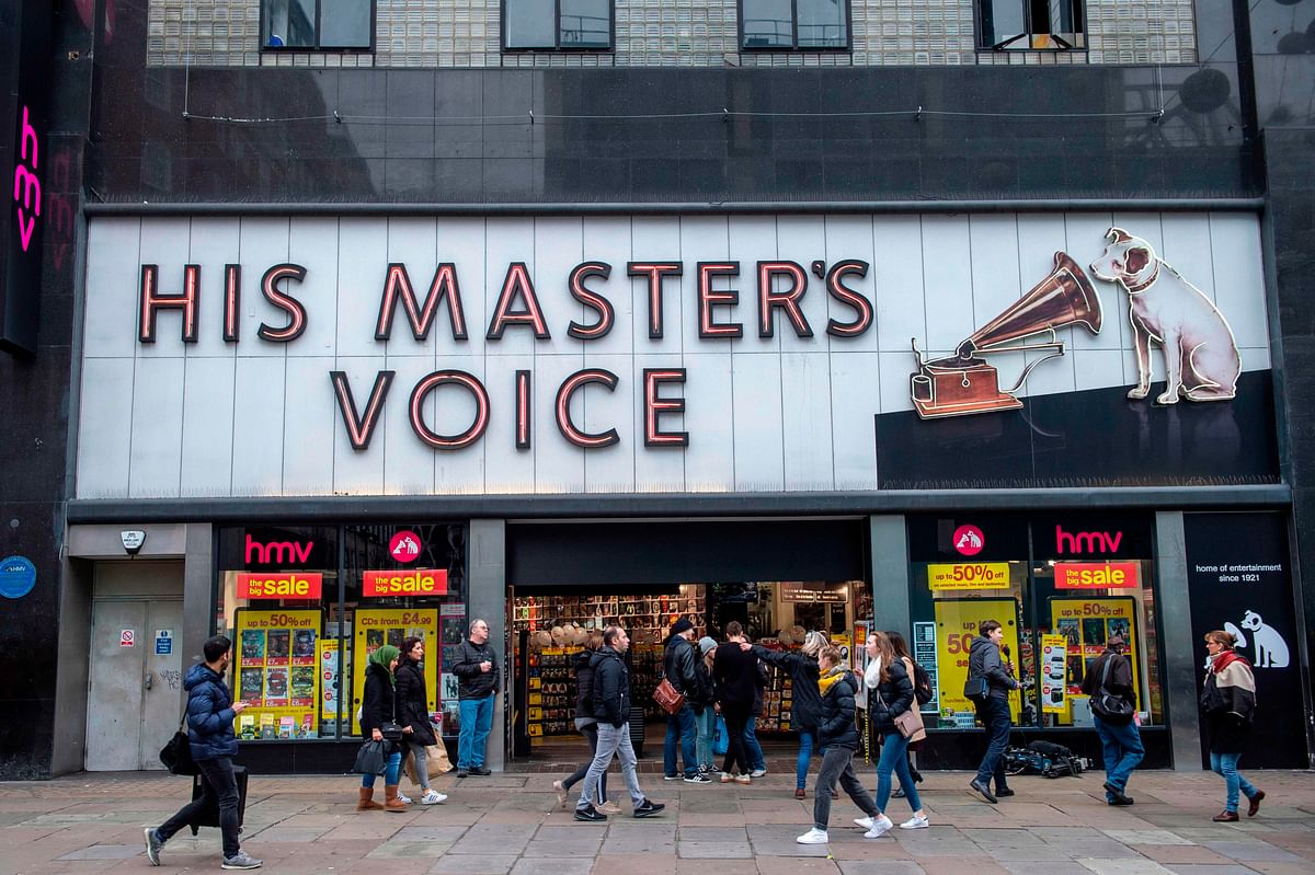 In this file photo taken on 28 December 2018, pedestrians walk past a HMV store in central London. Despite the UK retail crisis, Doug Putman, the new owner of the HMV record store, says he can reinvent the famous brand just saved from bankruptcy, backed up by vinyls, pop-koreans and brand new stores. Photo: AFP