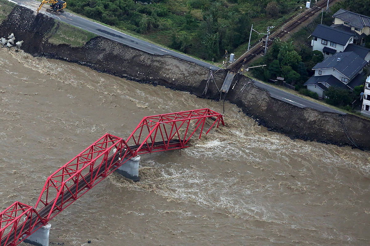 This aerial view shows a damaged train bridge over the swollen Chikuma river in the aftermath of Typhoon Hagibis in Ueda, Nagano prefecture on 13 October 2019. Photo: AFP