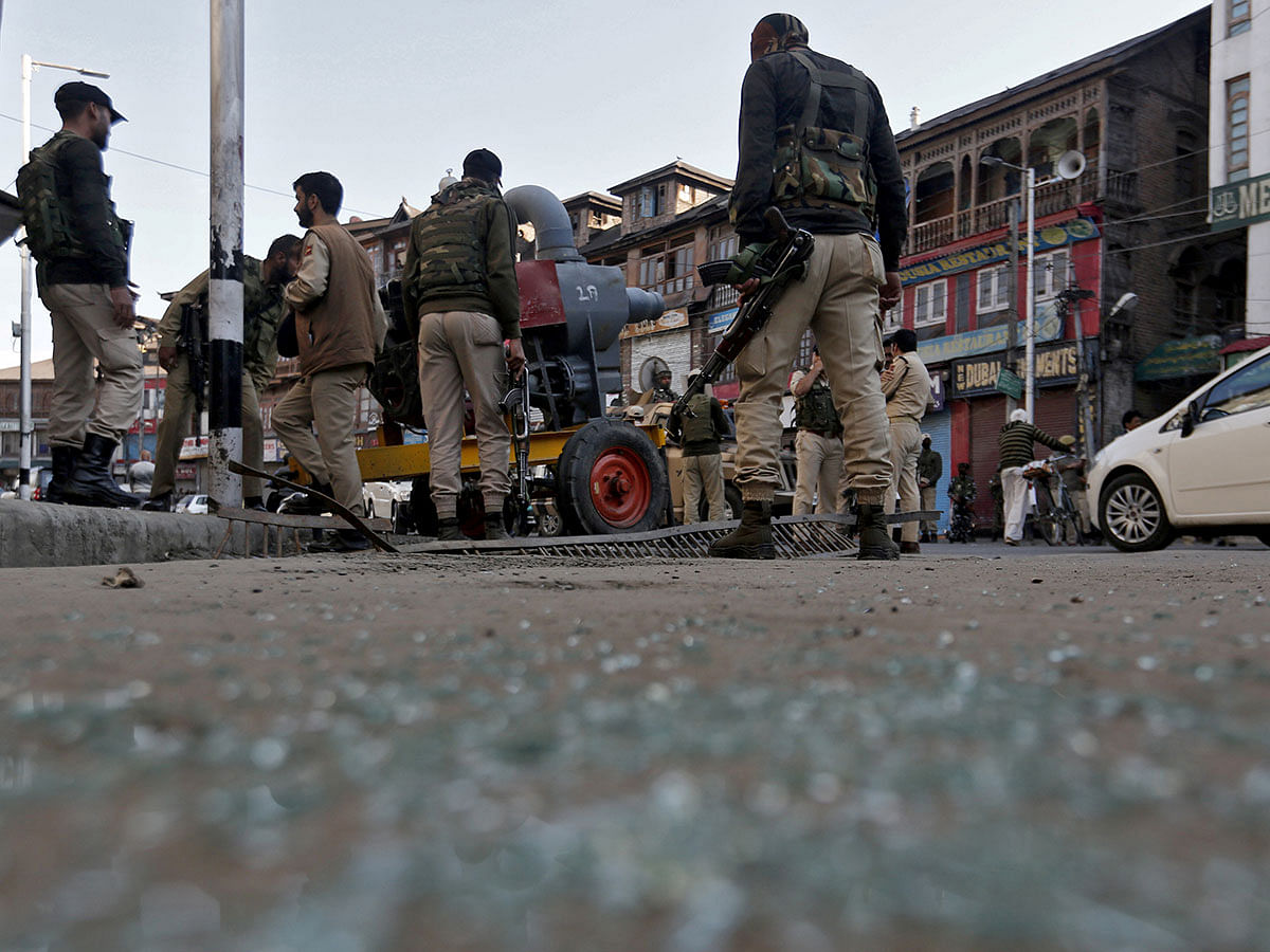 Indian police officers stand at the site of a grenade attack in Srinagar on 12 October 2019. Photo: Reuters