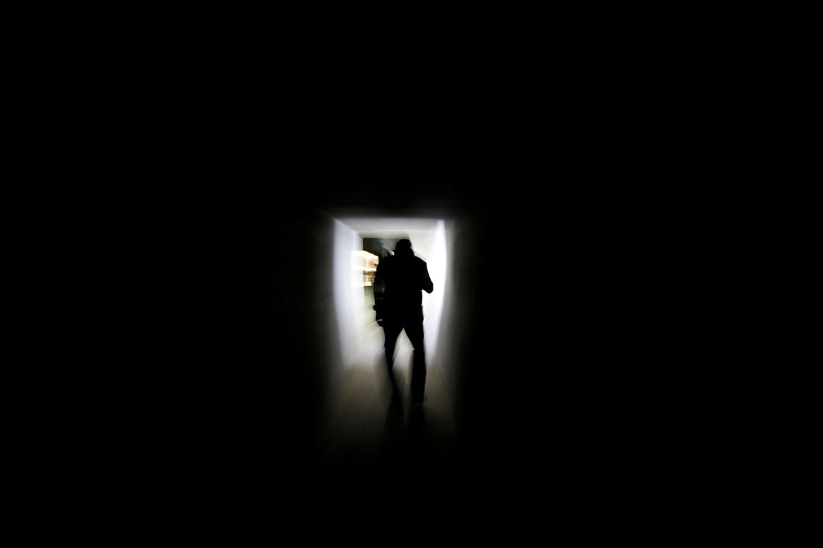 A Thai police Narcotics Suppression Division officer walks through a tunnel inside a raided compound belonging to Sue Songkittikul, a suspected Sam Gor syndicate operations chief, in Mae Sot. Photo: Reuters