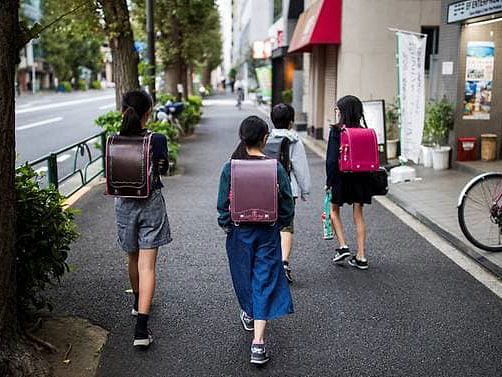 School children walk home along a road in the Ogikubo district of Tokyo, on 7 Oct, 2019. Photo: AFP