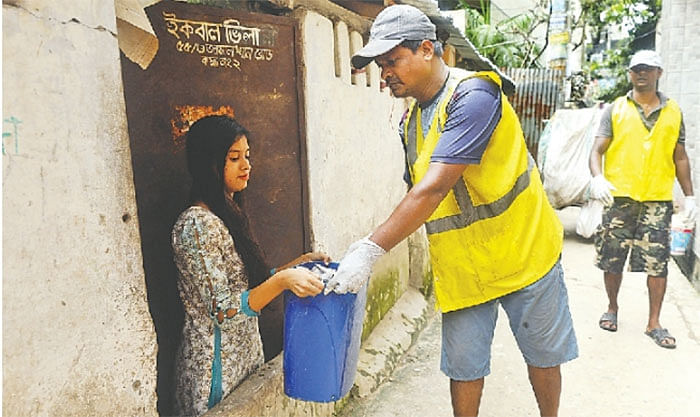 Cleaners of Chattogram City Corporation collect garbage from a residence in Chattogram on Wednesday. Photo: Sowrav Das