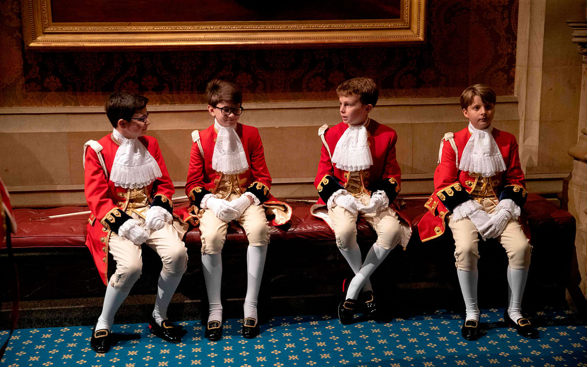 Page boys sit together before the arrival of Britain`s Queen Elizabeth II in the Norman Porch at the Palace of Westminster for the State Opening of Parliament in the Houses of Parliament in London on 14 October 2019. Photo: AFP