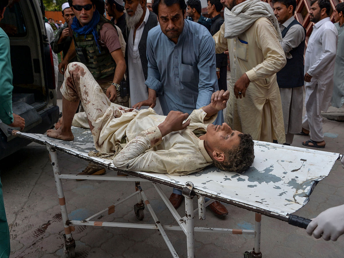 Volunteers carry an injured man on a stretcher to a hospital, following a bomb blast in Haska Mina district of Nangarhar province in Afghanistan on 18 October, 2019. Photo: AFP