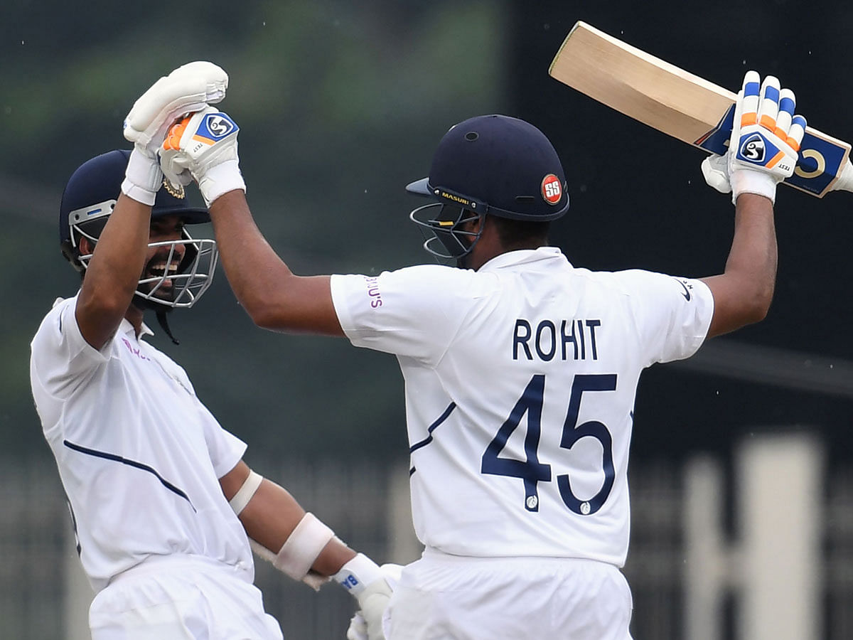 India`s Rohit Sharma (R) celebrates his century (100 runs) with teammate Ajinkya Rahane during the first day of the third and final Test match between India and South Africa at the Jharkhand State Cricket Association (JSCA) stadium in Ranchi on Saturday. Photo: AFP