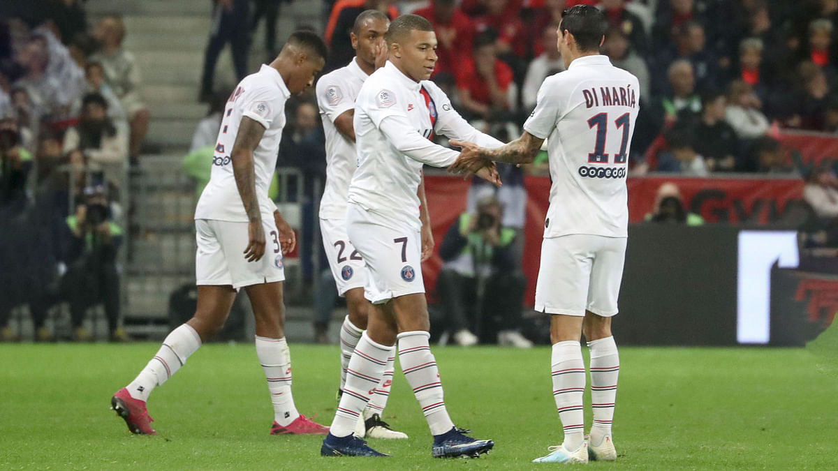 Paris Saint-Germain`s French forward Kylian Mbappe (C) is congratulated by Paris Saint-Germain`s Argentine midfielder Angel Di Maria (R) after scoring a goal during the French L1 football match between OGC Nice (OGCN) and Paris Saint-Germain (PSG) at `Allianz Riviera` stadium in Nice, southern France, on Friday. Photo: AFP