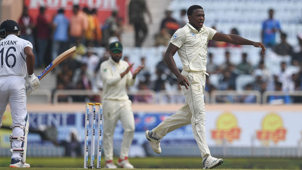 South African cricketer Kagiso Rabada (R) reacts after taking the wicket of Indian cricketer Mayank Agarwal (L) during the third and final Test match between India and South Africa at the Jharkhand State Cricket Association (JSCA) stadium in Ranchi on 19 October 2019. Photo: AFP