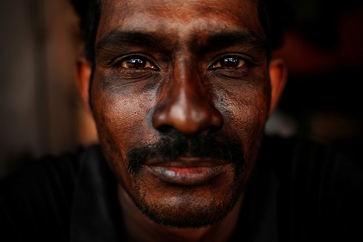TyresA Bangladeshi worker reacts to the camera as he takes a break at a tyre pyrolysis plant in Kulai. Photo: Reuters