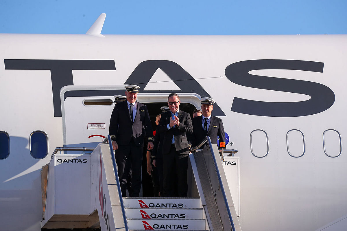 In this handout photo from Qantas shows Qantas Group CEO Alan Joyce (C) and crew exiting a Qantas Boeing 787 Dreamliner plane after arriving at Sydney international airport after completing a non-stop test flight from New York to Sydney on 20 October 2019. Photo: AFP