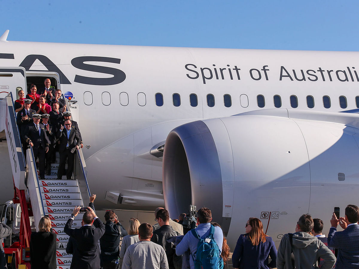 In this handout photo from Qantas shows Qantas Group CEO Alan Joyce and crew exiting a Qantas Boeing 787 Dreamliner plane after arriving at Sydney international airport after completing a non-stop test flight from New York to Sydney on 20 October 2019. Photo: AFP