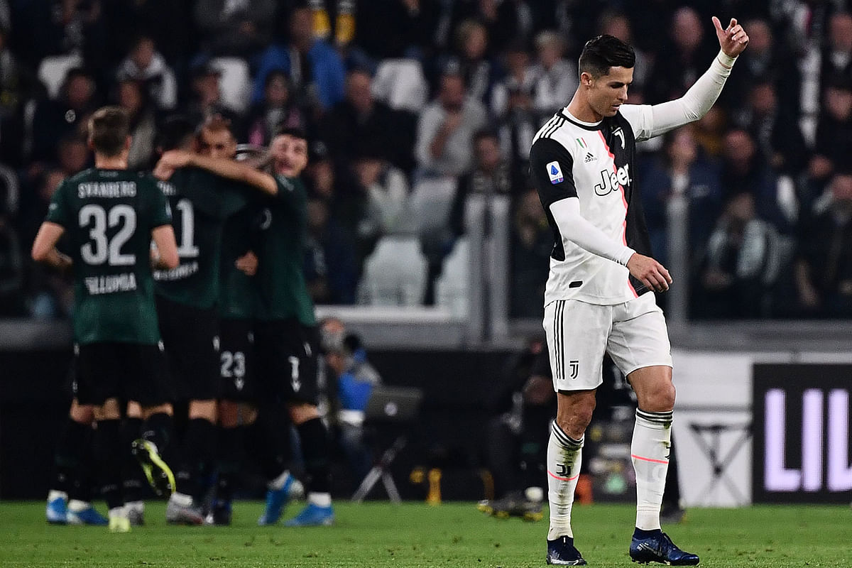 Juventus` Portuguese forward Cristiano Ronaldo (R) reacts as Bologna`s players celebrate after scoring an equalizer during the Italian Serie A football match Juventus vs Bologna on Saturday at the Juventus stadium in Turin. Photo: AFP
