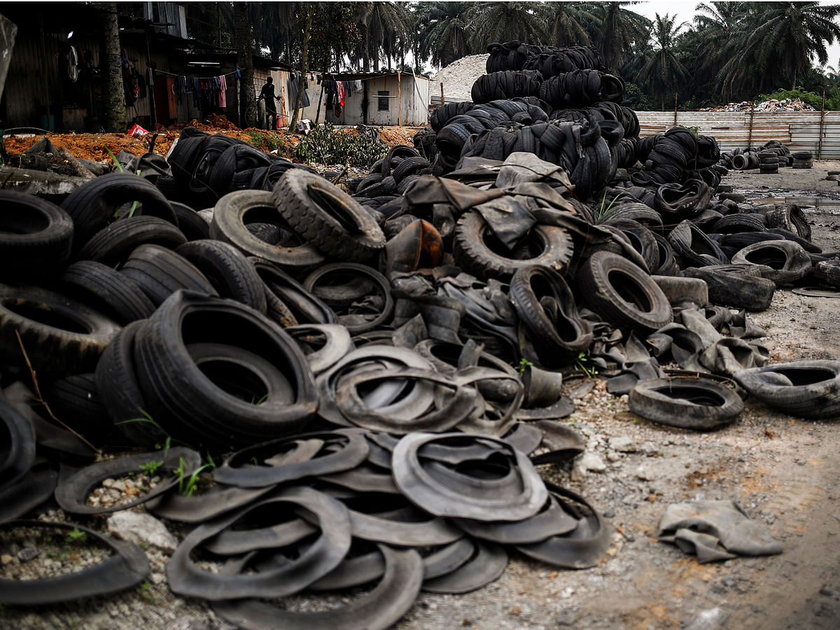 Bales of tyres from Australia and New Zealand are dumped at a compound next to the living quarters of the workers at a tyre pyrolysis plant in Kulai, Johor, Malaysia 7 August 2019. Photo: Reuters
