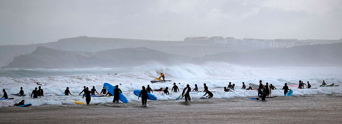 A Lifeguard riding a jet ski patrols the water as surfers and bodyboarders go into the sea at Towan Beach in Newquay, south west England on 18 October 2019. Photo: AFP