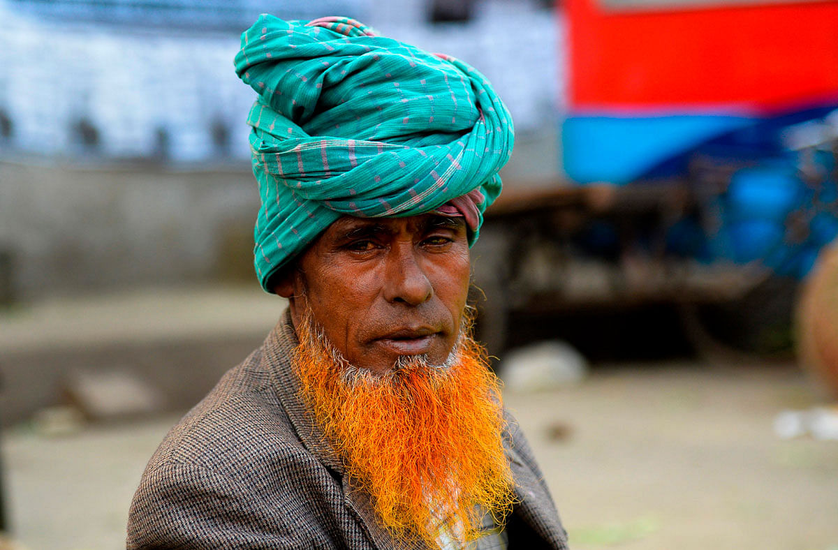 In this photo taken on 24 December 2018 vegetable vendor and henna enthusiast Mohammad Ahmed Ali with a henna-dyed beard poses for a photo in Dhaka. Photo: AFP