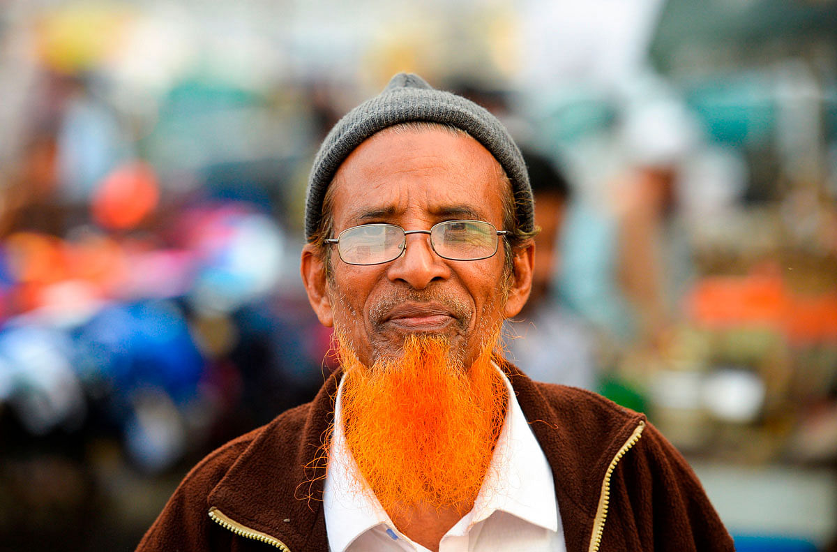In this photo taken on 24 December 2018, henna enthusiast Eklas Ahmed with a henna-dyed beard poses for a photo in Dhaka. Photo: AFP
