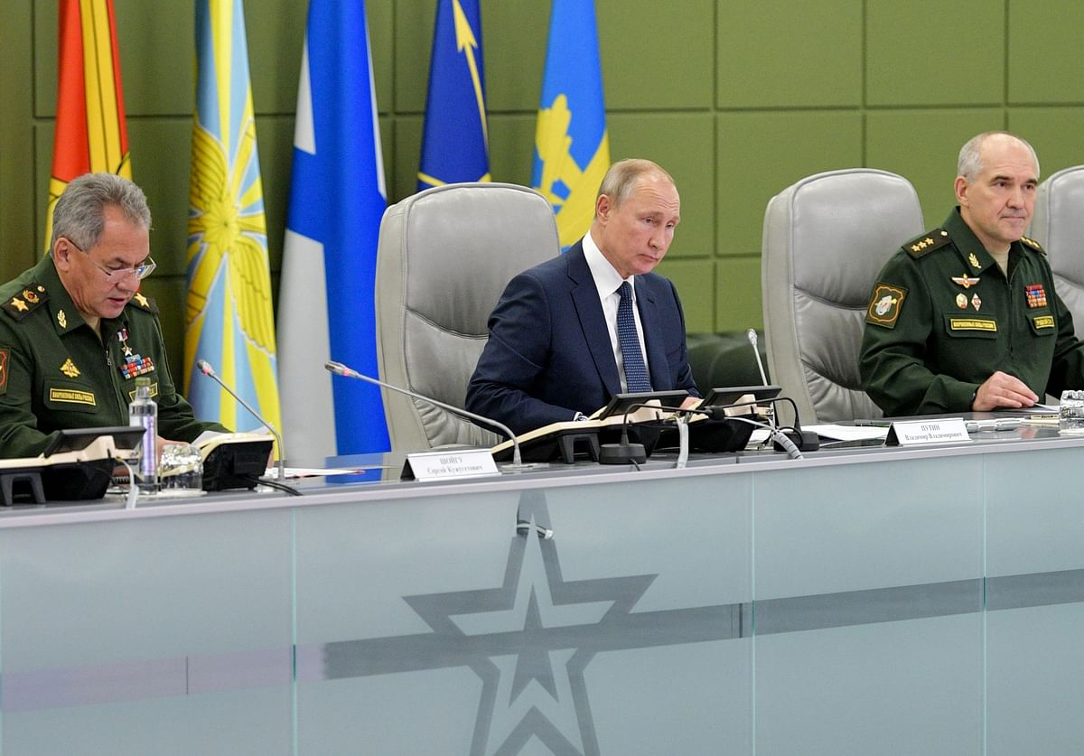 Russian president Vladimir Putin (C) sits with Defence Minister Sergei Shoigu (L) and the Chief of the Main Operational Directorate of the Russian General Staff Sergei Rudskoy as he observes military exercises during a visit at the National Centre for State Defence Control, in Moscow on 17 October 2019. AFP File Photo