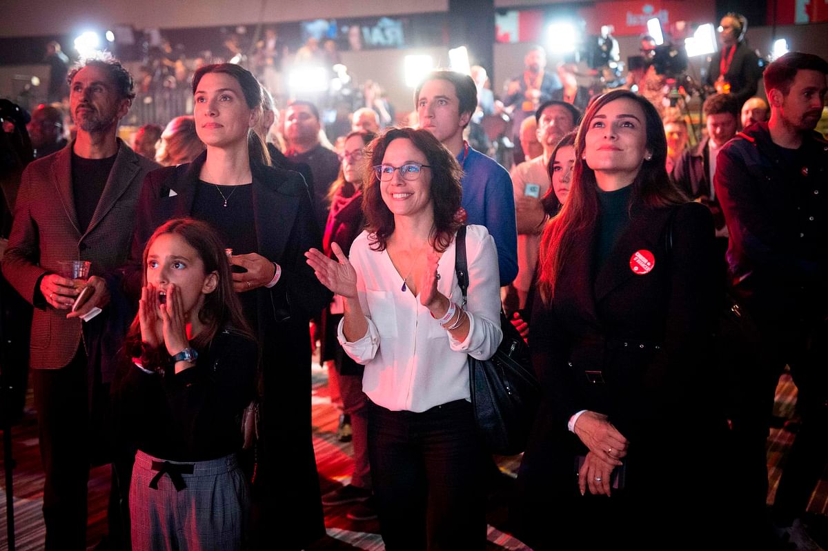 Supporters of Liberal party candidate, Justin Trudeau, react to the announcements of the first results at the Palais des Congres in Montreal during Team Justin Trudeau 2019 election night event in Montreal, Canada on 21 October. Photo: AFP