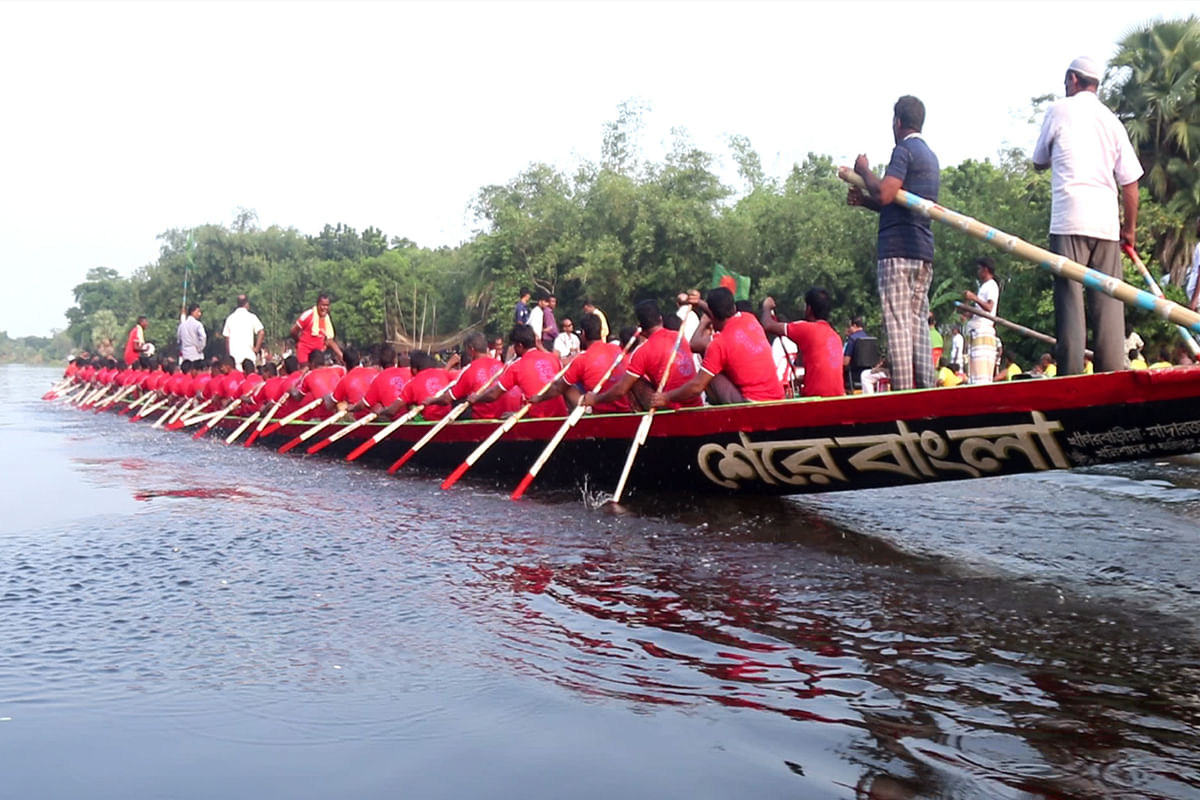 A boat named `Sher-e-Bangla` ready to race while a Bangladesh flag flies from the deck.
