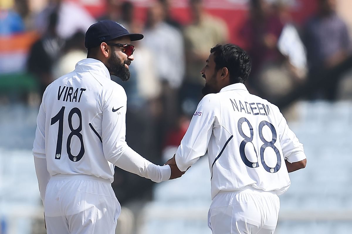 India`s cricket team captain Virat Kohli (L) shakes hands with teammate Shahbaz Nadeem after their victory at the end of the third and final Test match between India and South Africa at the Jharkhand State Cricket Association (JSCA) stadium in Ranchi on 22 October 2019. Photo: AFP
